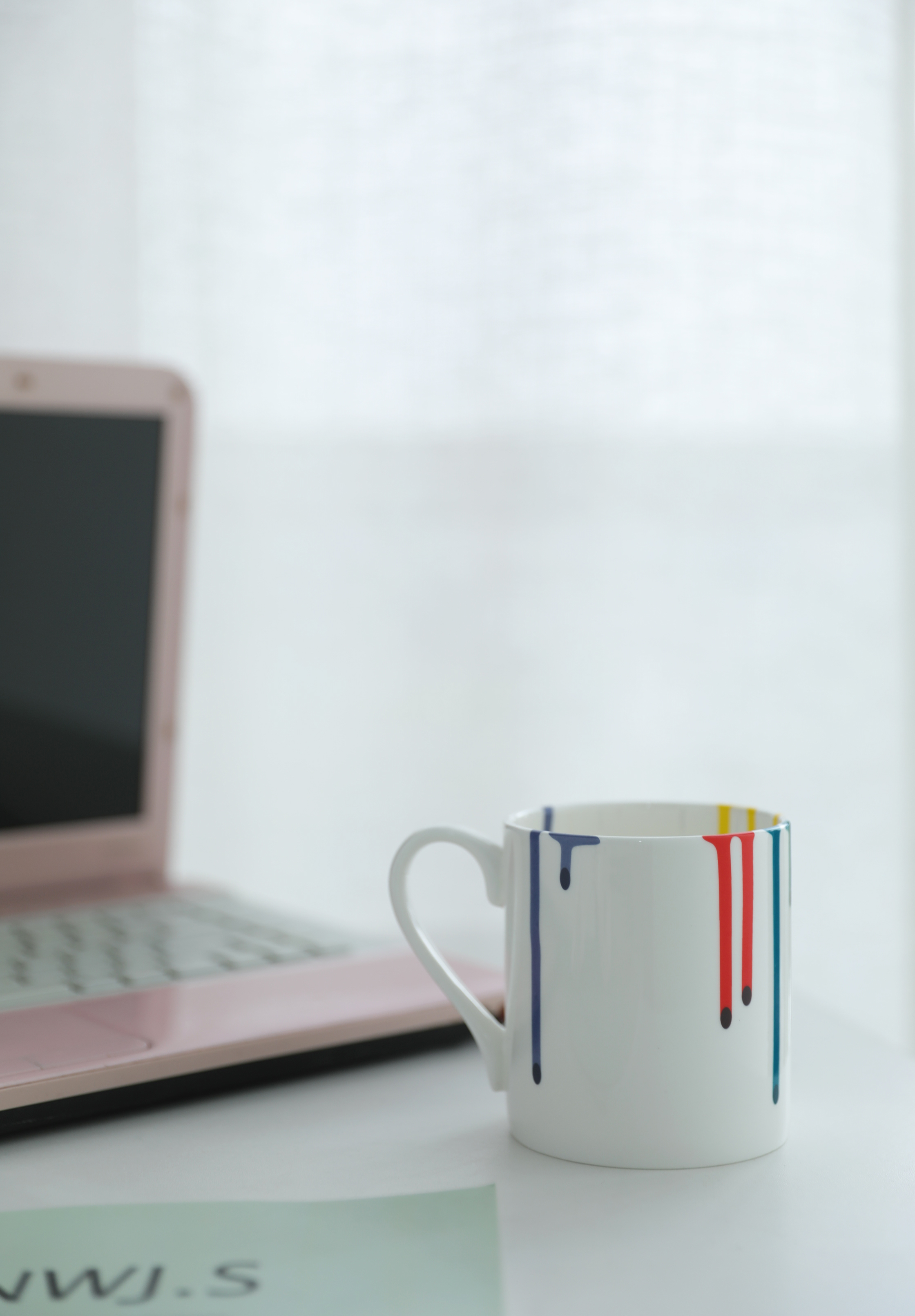 Minimalist ceramic mug with hand-painted dripped color accents
