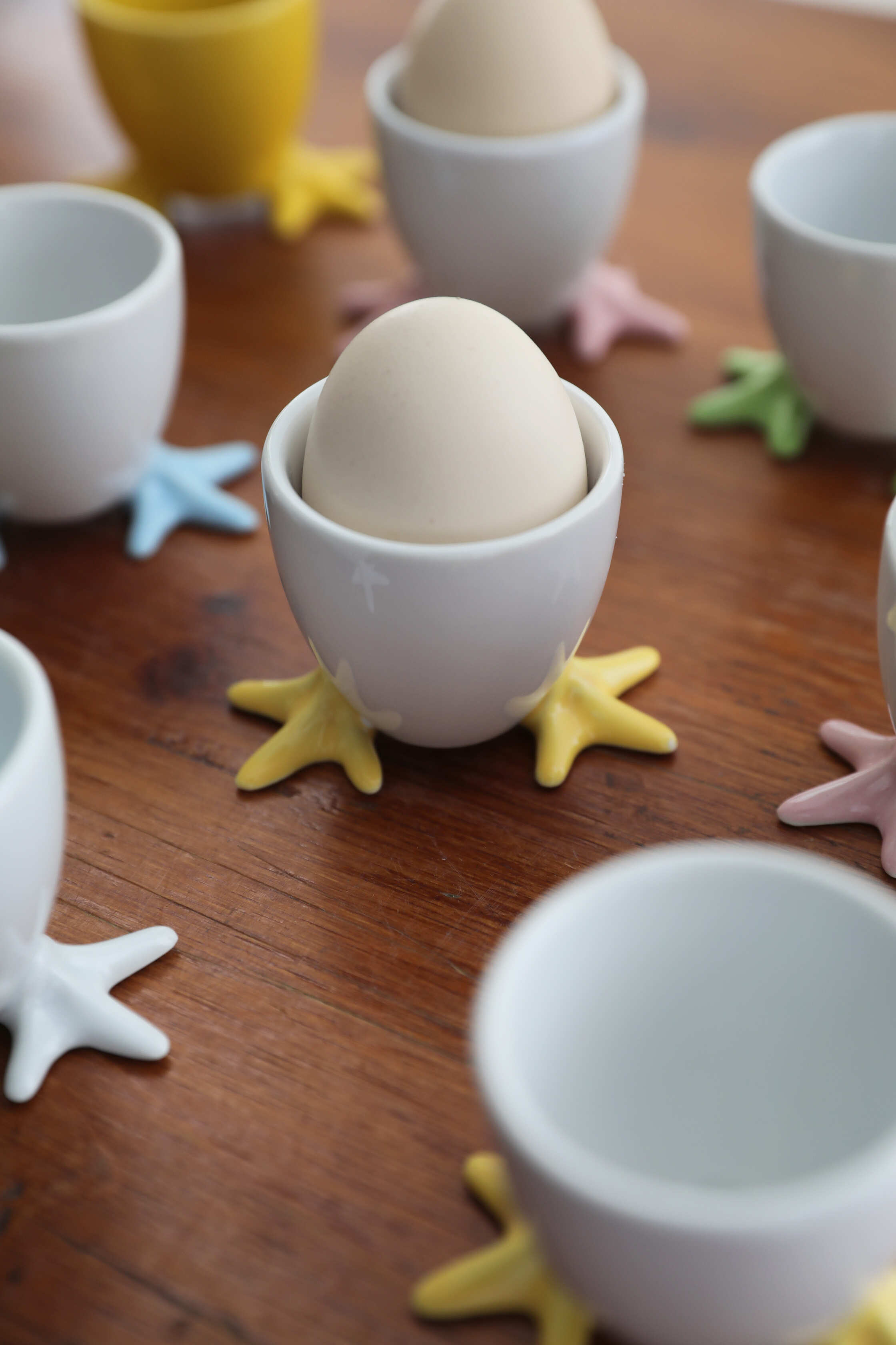 Two piece porcelain egg cup set with playful chick feet in soft pastel colors