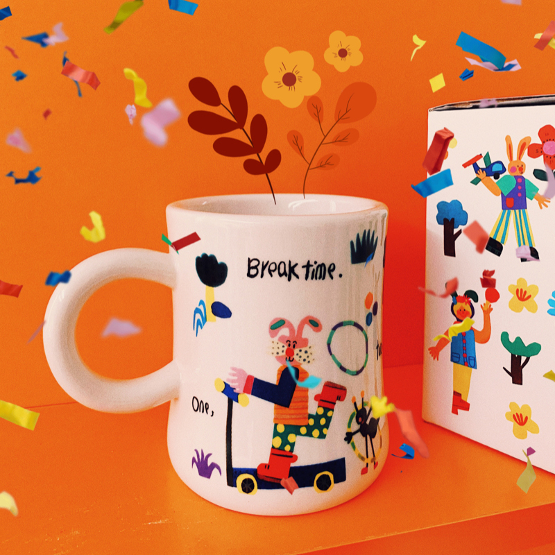 Ceramic mug hand-painted with goofy rabbits on scooters in bright color