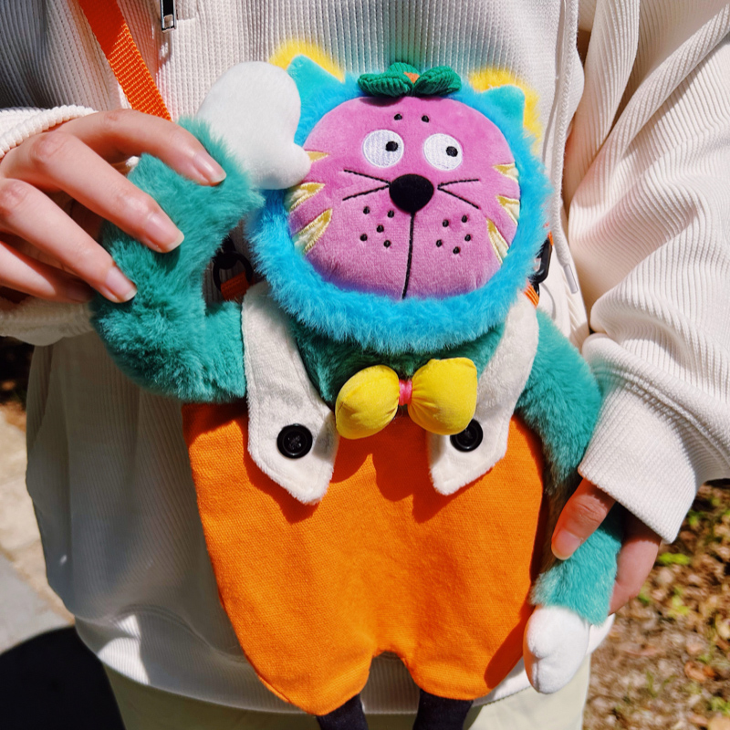 Fuzzy teal cat crossbody bag with a bubblegum-pink face