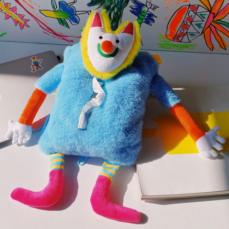 Plush tissue box cover that is half soft toy, half practical dispenser