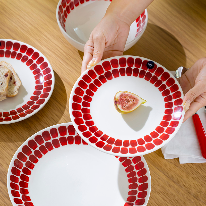 Porcelain dinnerware set in rich berry red with rhythmic petal brushstrokes