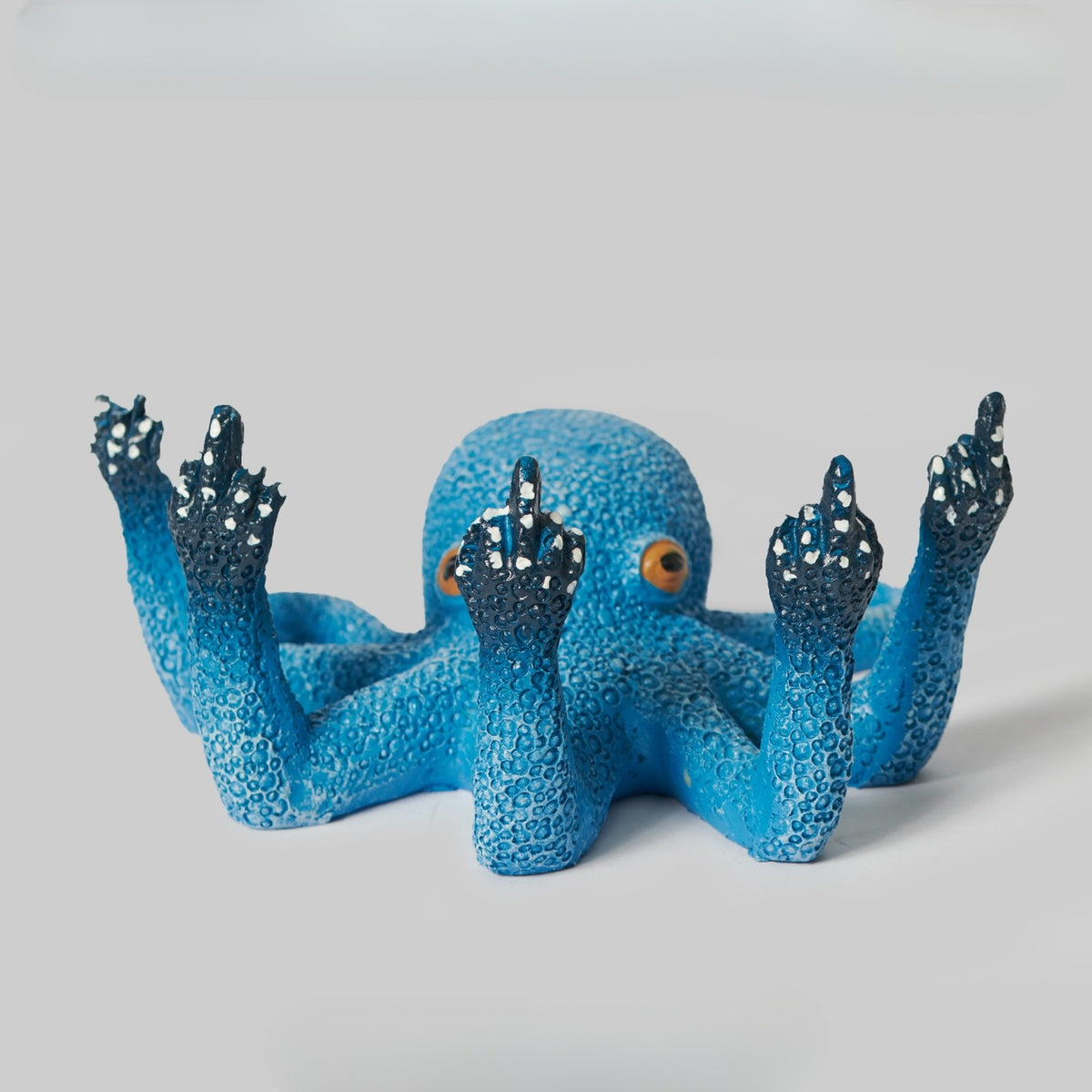 Bright blue ceramic octopus figurine with eight expressive arms and a look of pure disdain