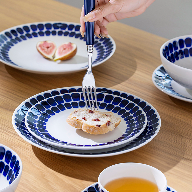 Nordic-style porcelain dinnerware set in deep twilight blue with petal-brushed rims