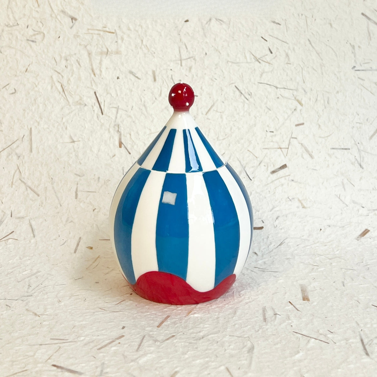 Hand-crafted ceramic storage jar inspired by vintage big-top tents