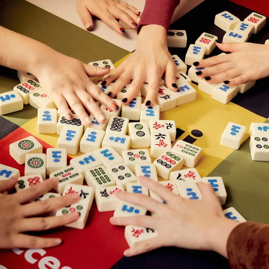 Mini mahjong set with traditional tiles and a bold graphic twist, in a collectible checkered case