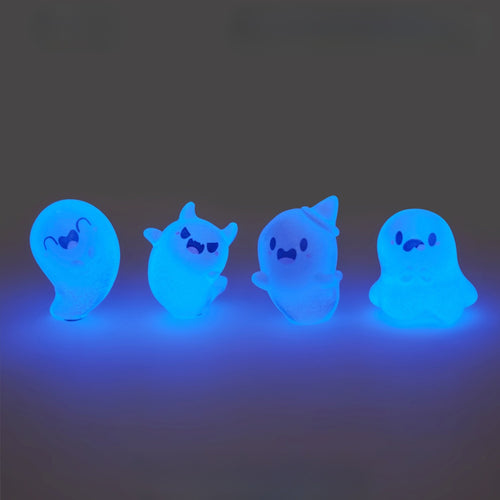 Gang of glow-in-the-dark ghost figurines with silly little faces