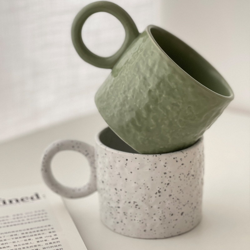 Textured ceramic mug with an oversized round handle and a gently bumpy surface