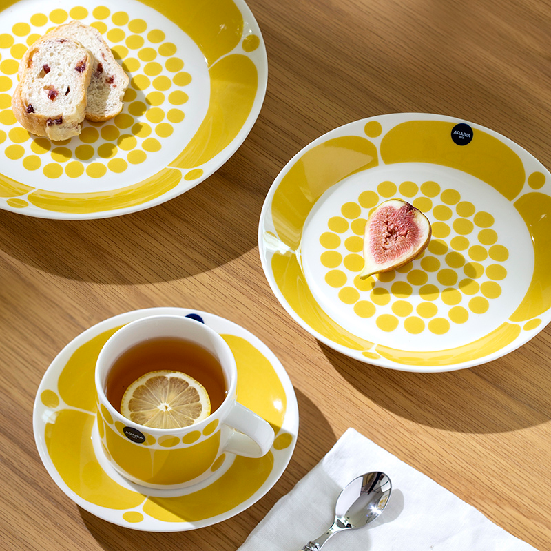 Yellow polka-dot ceramic plate with blooming petal detail