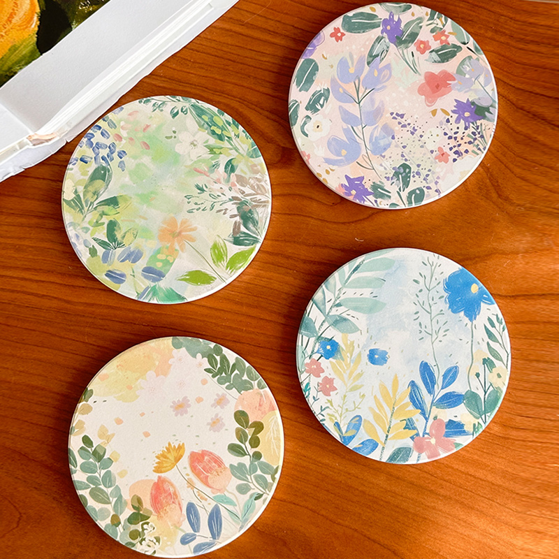 Set of four ceramic coasters, each hand-painted as its own wildflower meadow