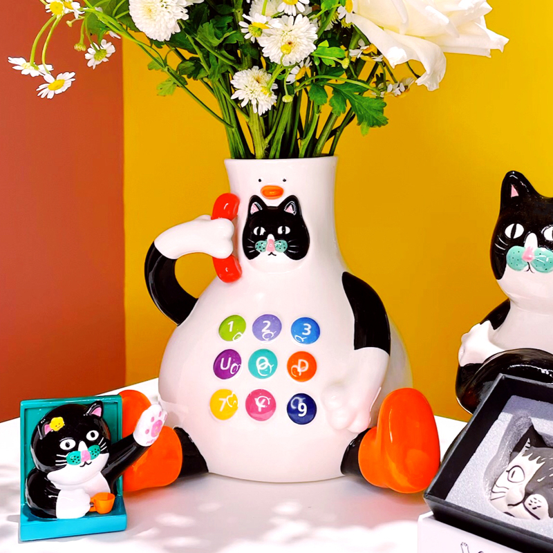 Glossy ceramic cat vase caught mid-conversation with your flowers